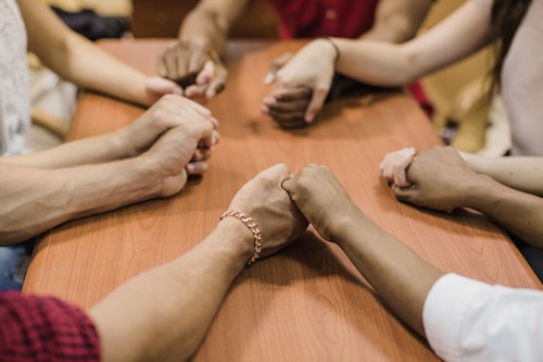anonymous people holding hands